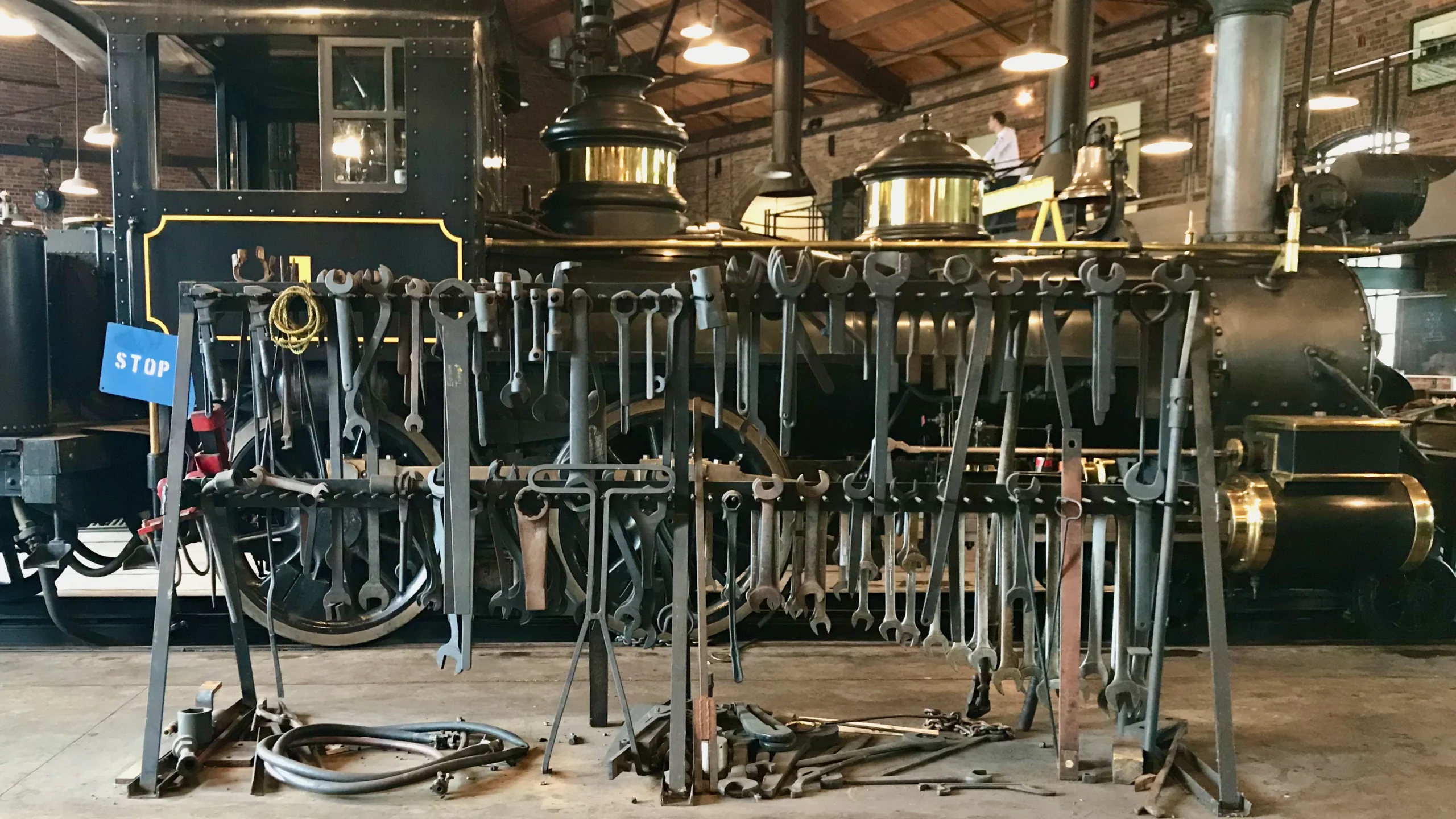 Historic locomotive workshop and tool rack representing customer operations transformation and a resilient commercial operating model.